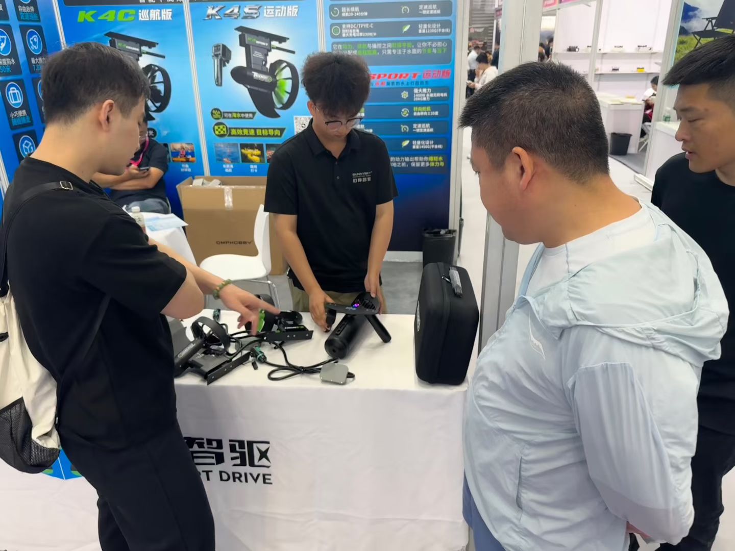 A Tedgix team member explains product features to potential buyers during a live booth demonstration at COSP Shenzhen 2026.