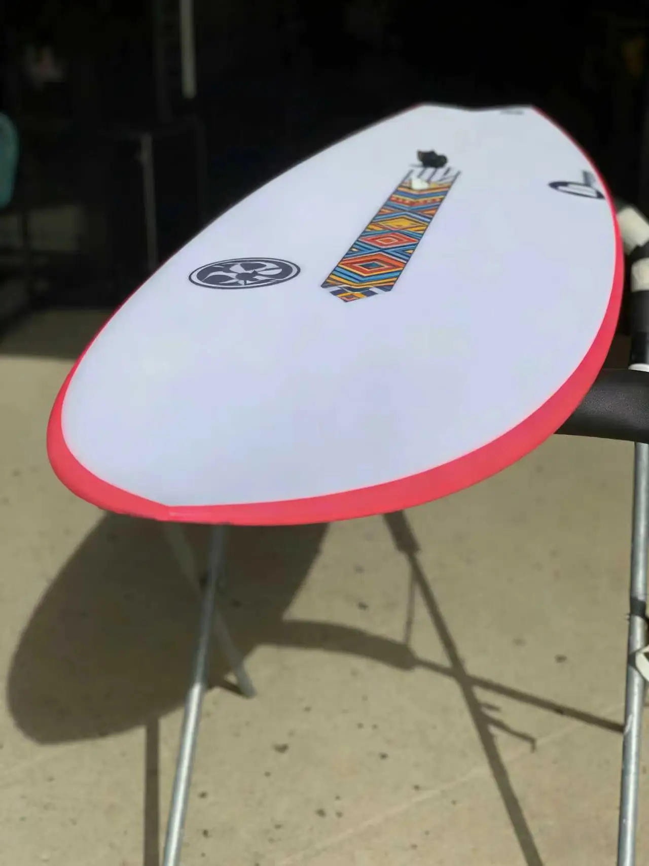 Close-up of a surfboard tail setup, highlighting the importance of a standard fin box for modular upgrades.
