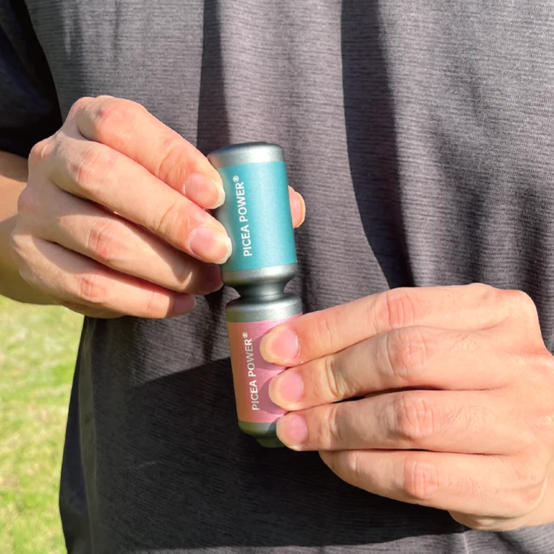 Hands demonstrating the modular connection of two TEDGIX TurboBean air pumps outdoors for increased pressure boosting.