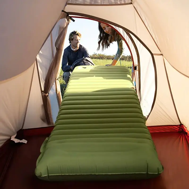 Fully inflated green camping mattress set up inside a tent using the TEDGIX TurboBean air pump.