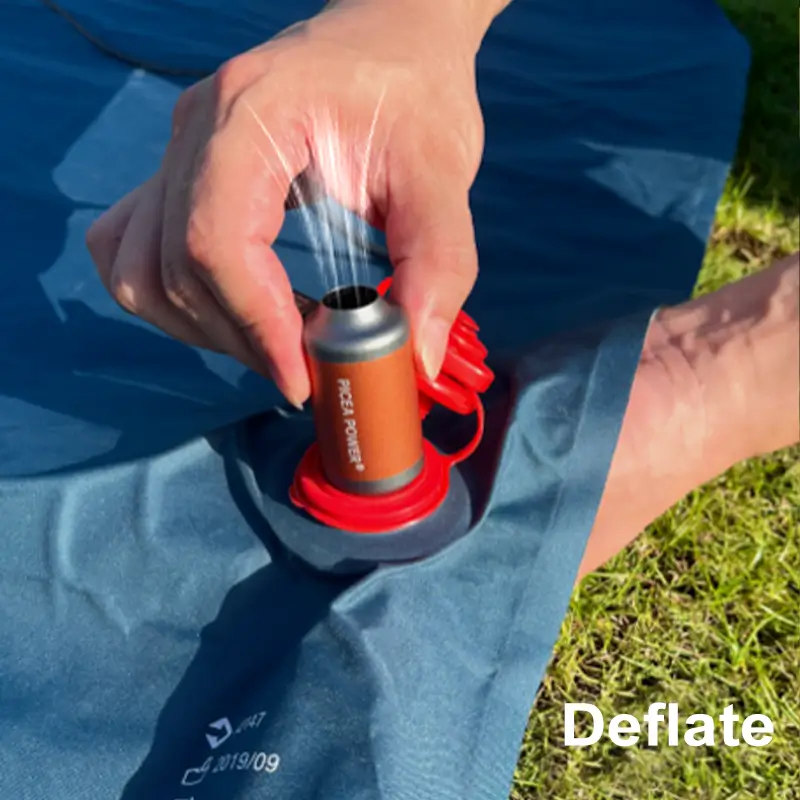 Close-up of TEDGIX TurboBean using the top deflation port to rapidly suck air out of a sleeping mat.